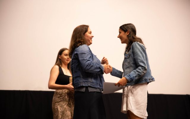 APDG Treasurer Valentina Iastrebova presents Isabella Gabreal with the Macquarie University Focus Award for Creative Achievement in Production Design